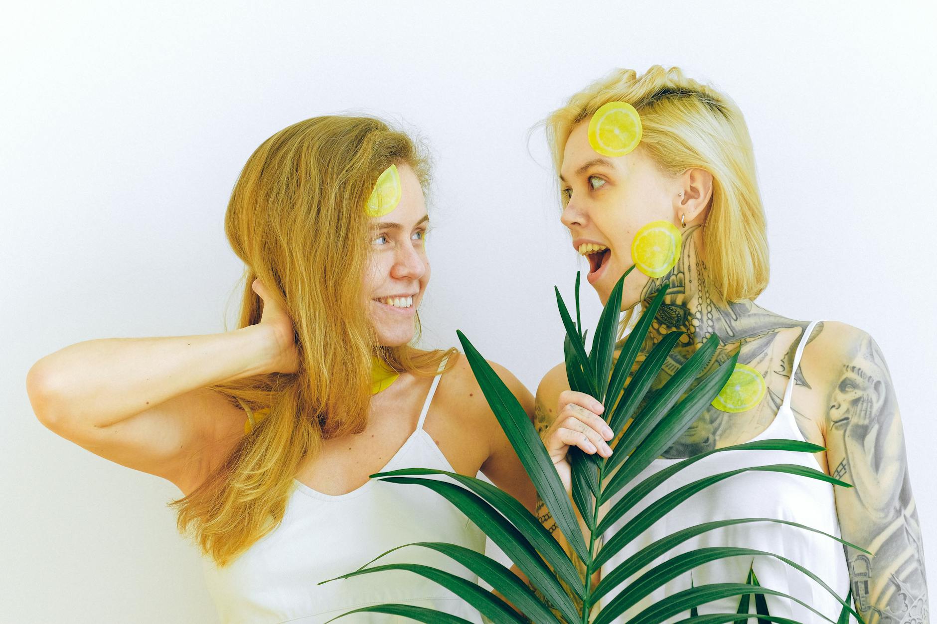 Hand holding a lemon on soft pink background surrounded by additional lemons, symbolizing perimenopause and estrogen changes