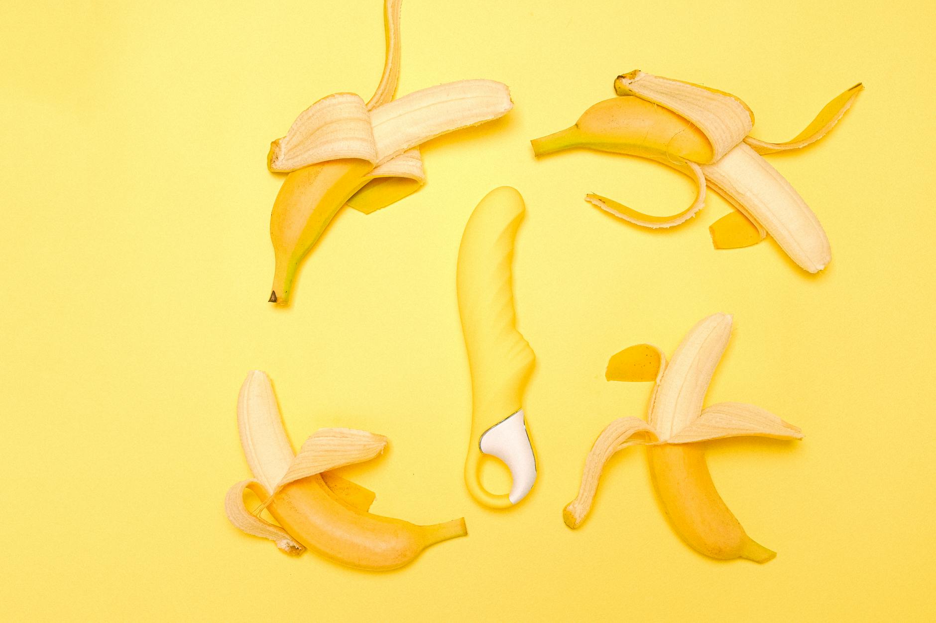 A person holding a lemon clitoral vibrator against a purple background, representing solo pleasure and reclaiming satisfaction.