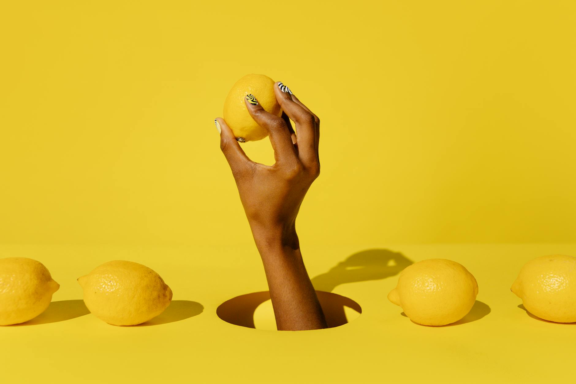 Two women smiling together with fresh lemons and tropical plants, expressing joy and openness
