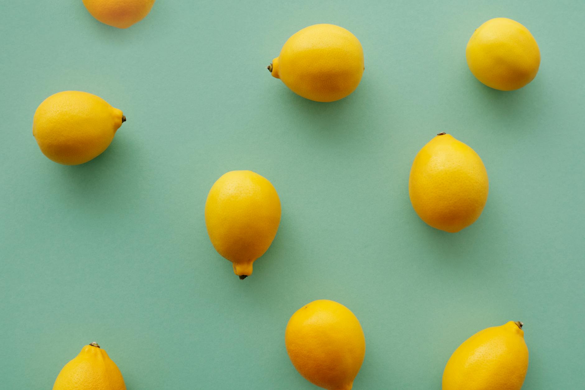 Bright yellow lemons arranged on a soft green background, symbolizing the varied nature of pleasure patterns