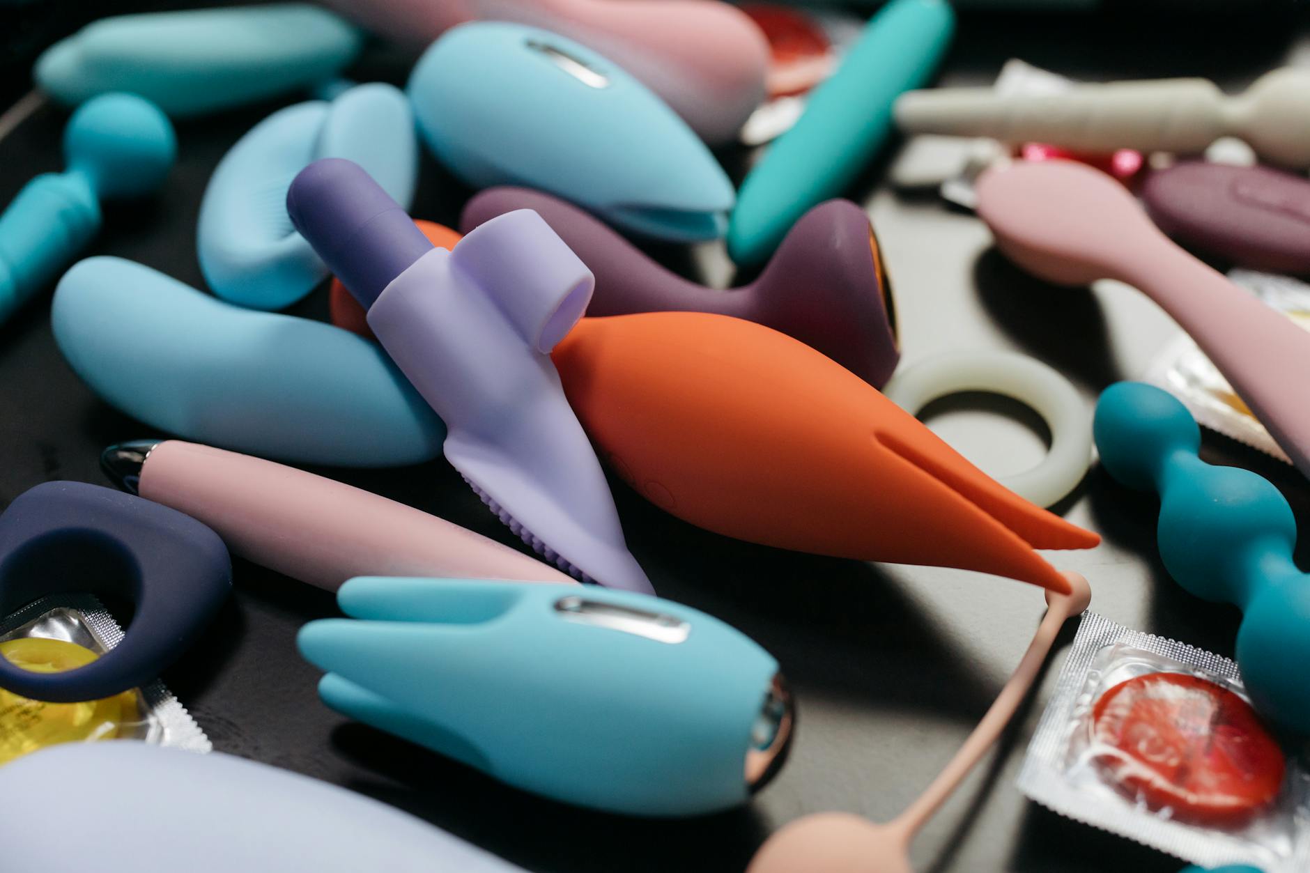 An array of colorful vibrators and toys displayed together, representing diverse pleasure options for couples