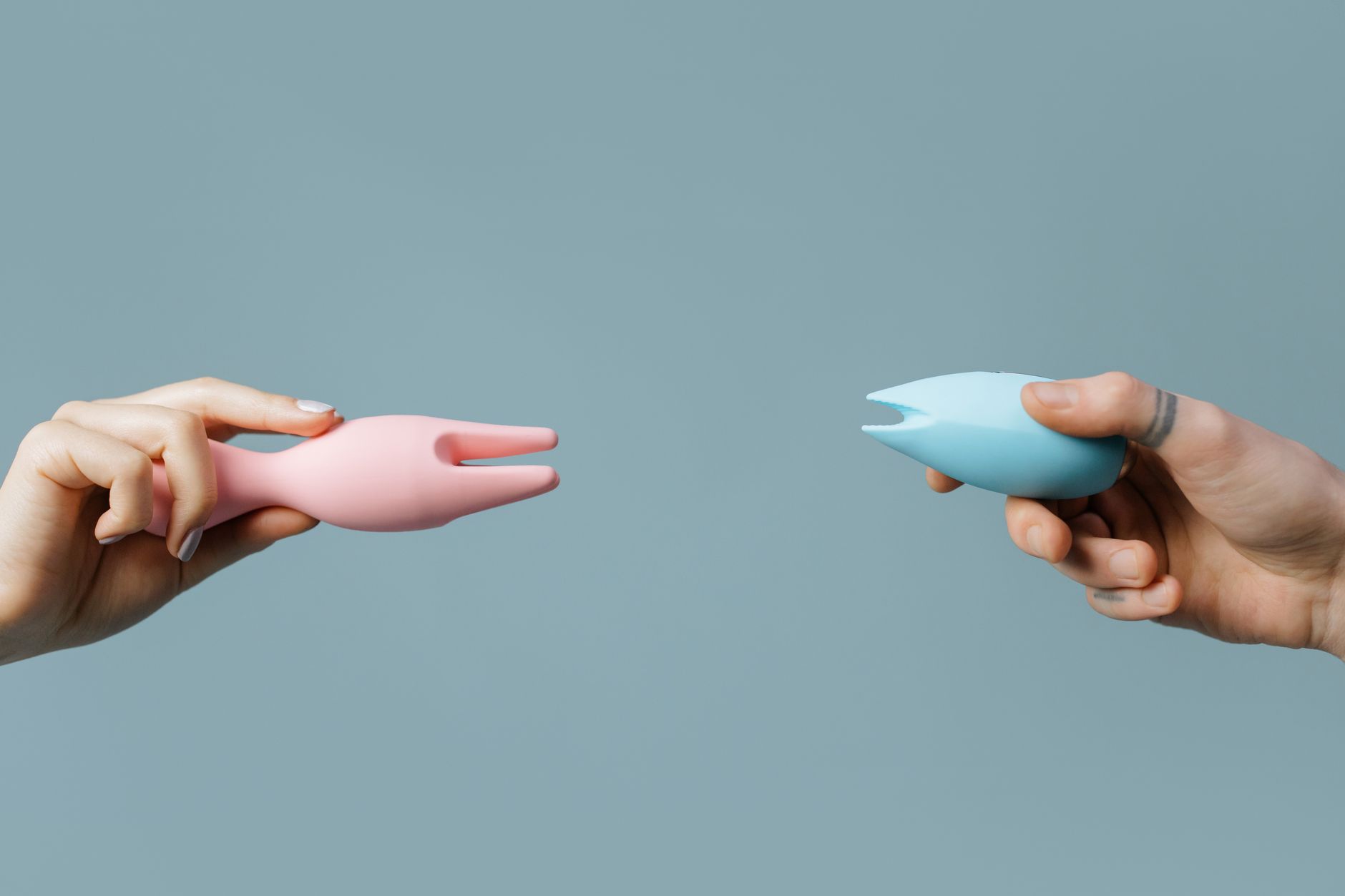 Hand holding a fresh lemon against a bright yellow background, symbolizing the Lemon Clit Vibrator and natural lubrication.
